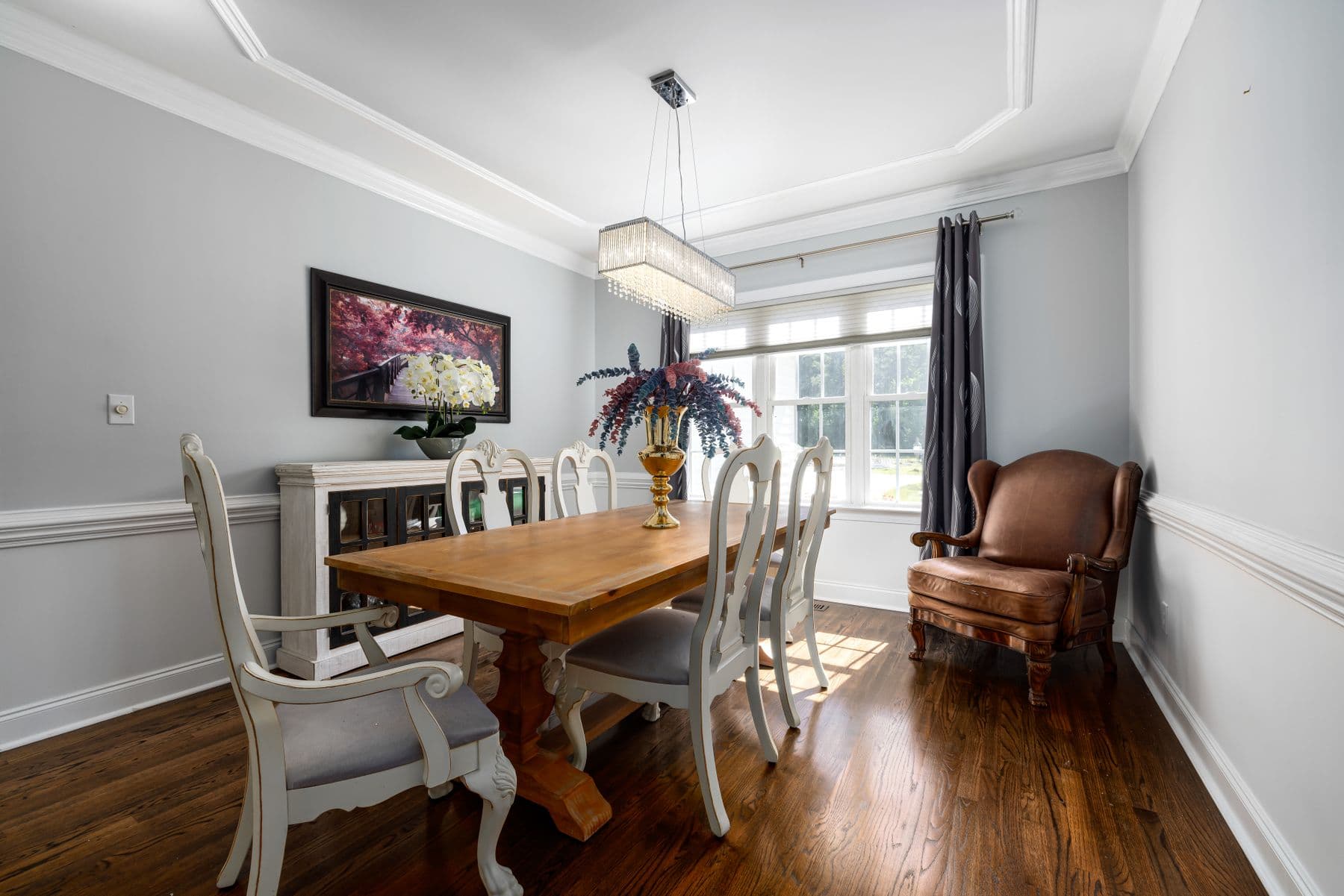 Dining table for four set beside the balcony doors with original tiled floor