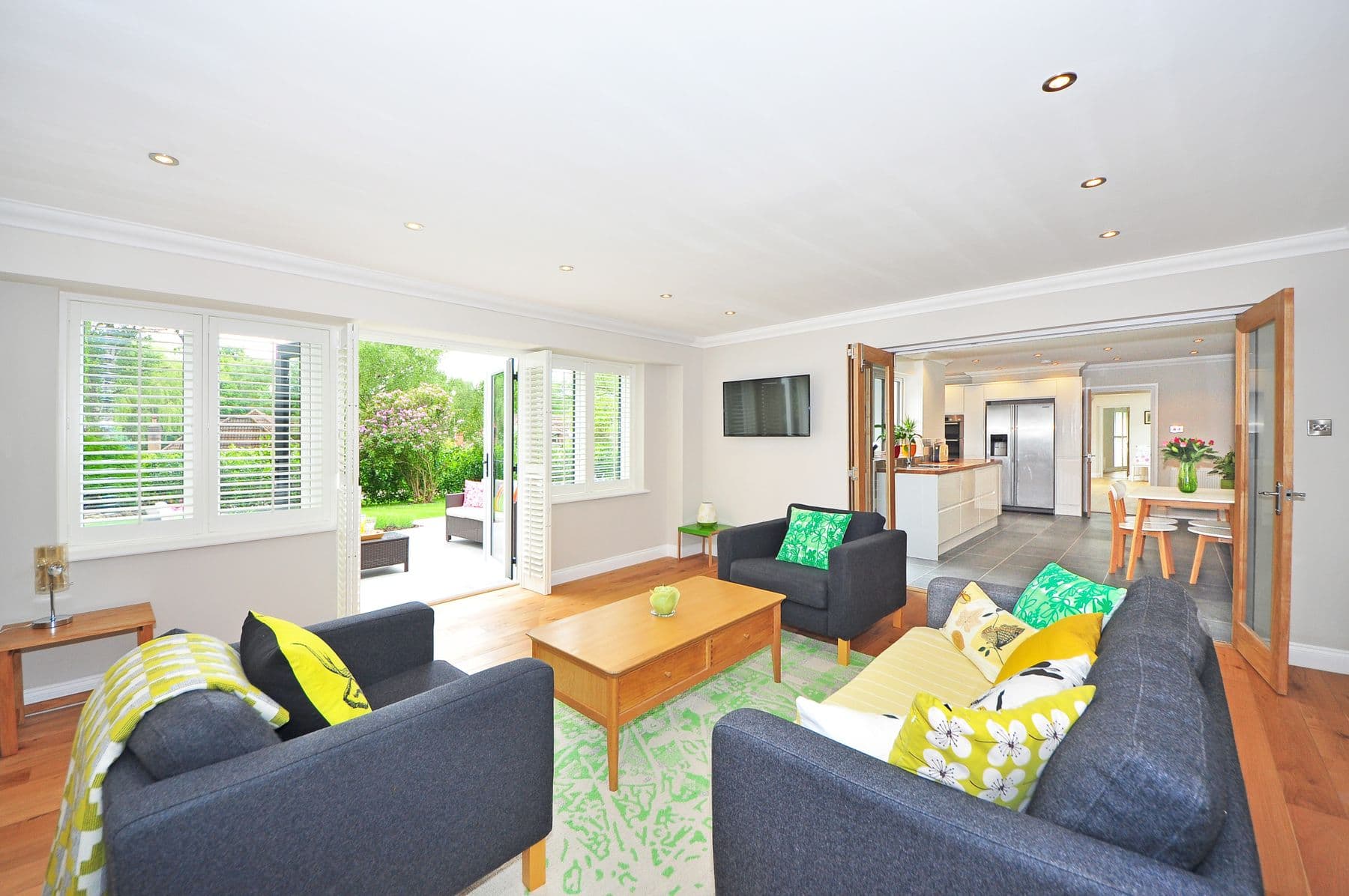 Sitting room with glass doors open to the pool terrace and mountain view