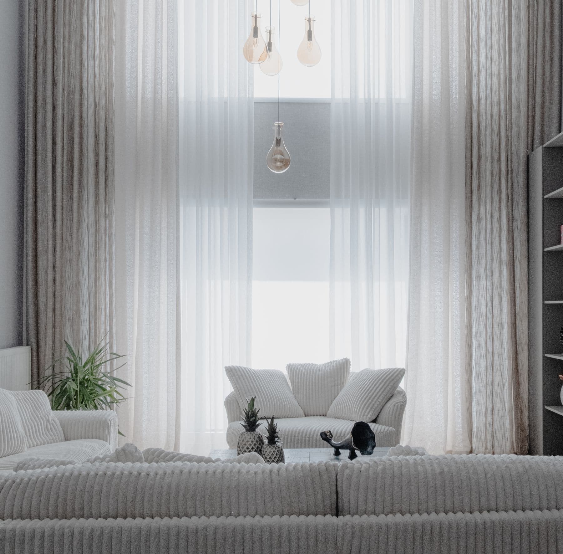 Living room with sliding doors open to the glazed terrace and the sea beyond