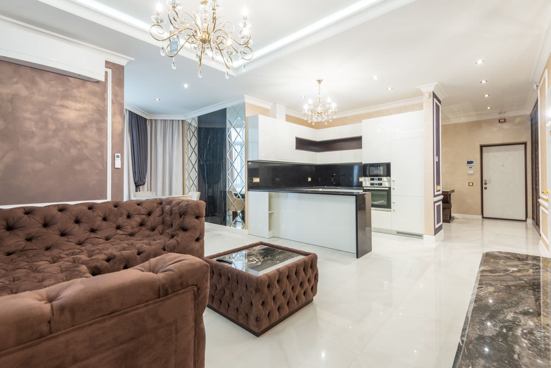 Double-height living room with glass doors open to the pool terrace