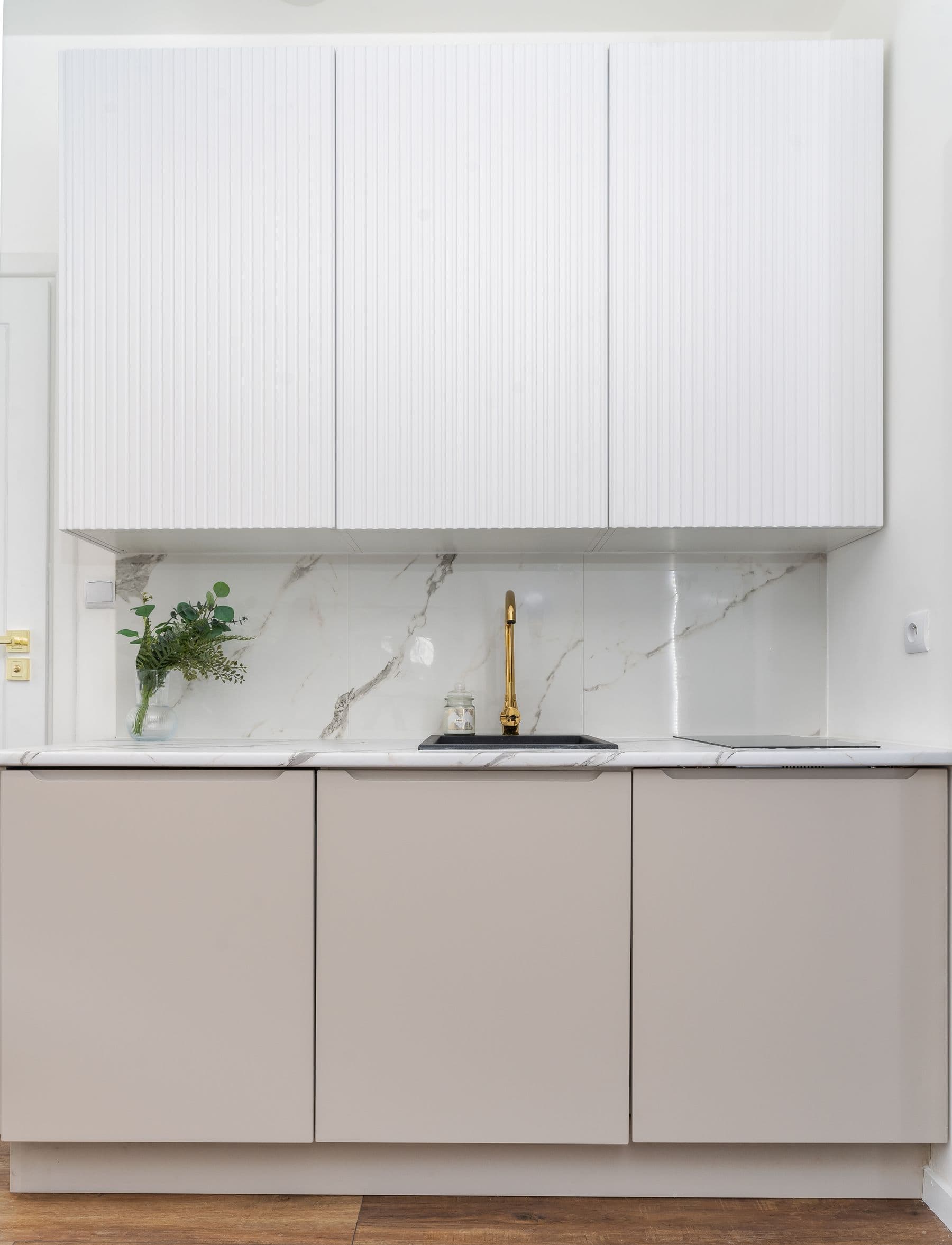 Kitchen with induction range, double ovens and marble island