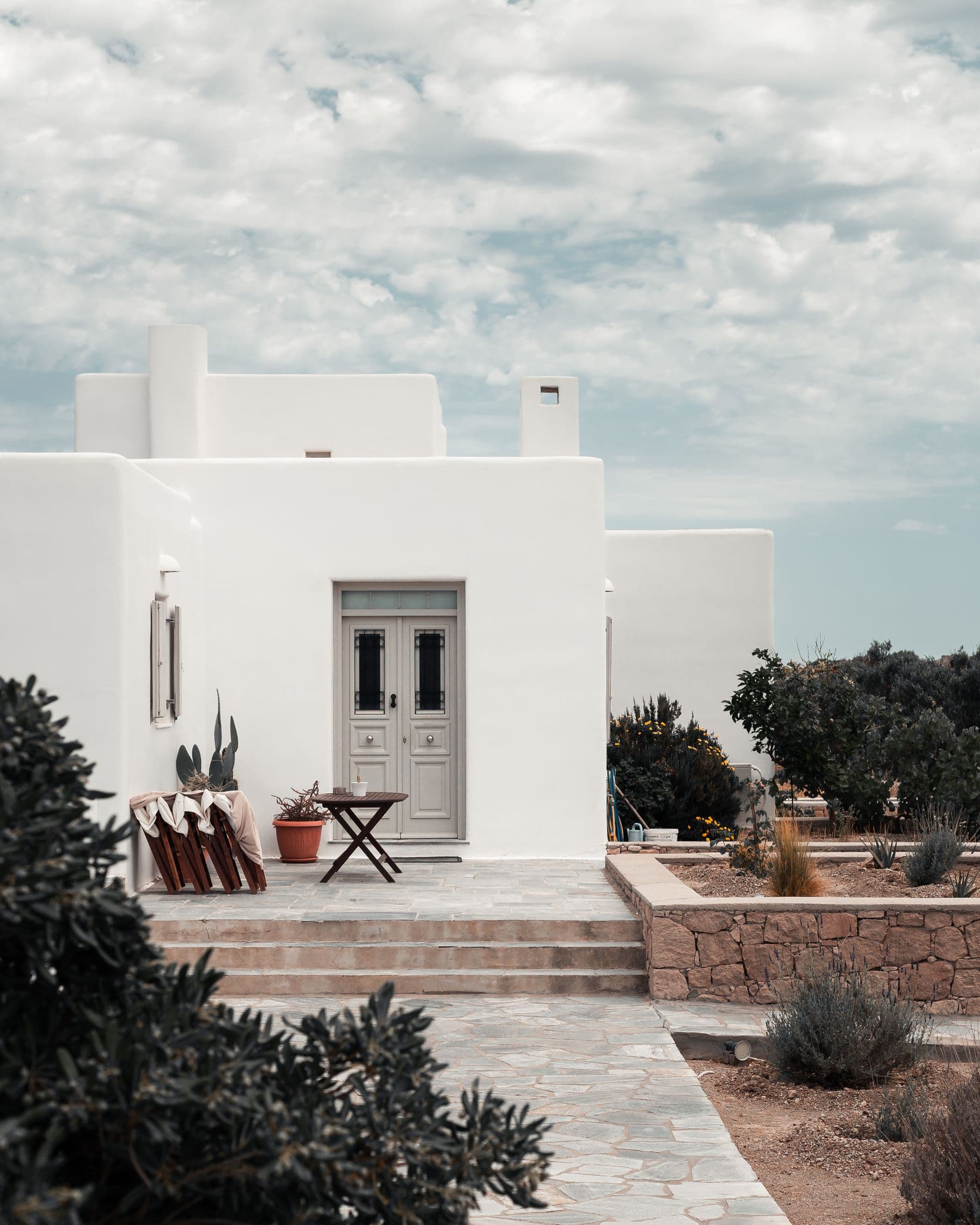Villa Caleta's facade and gated driveway on a quiet residential street in San Pedro de Alcántara